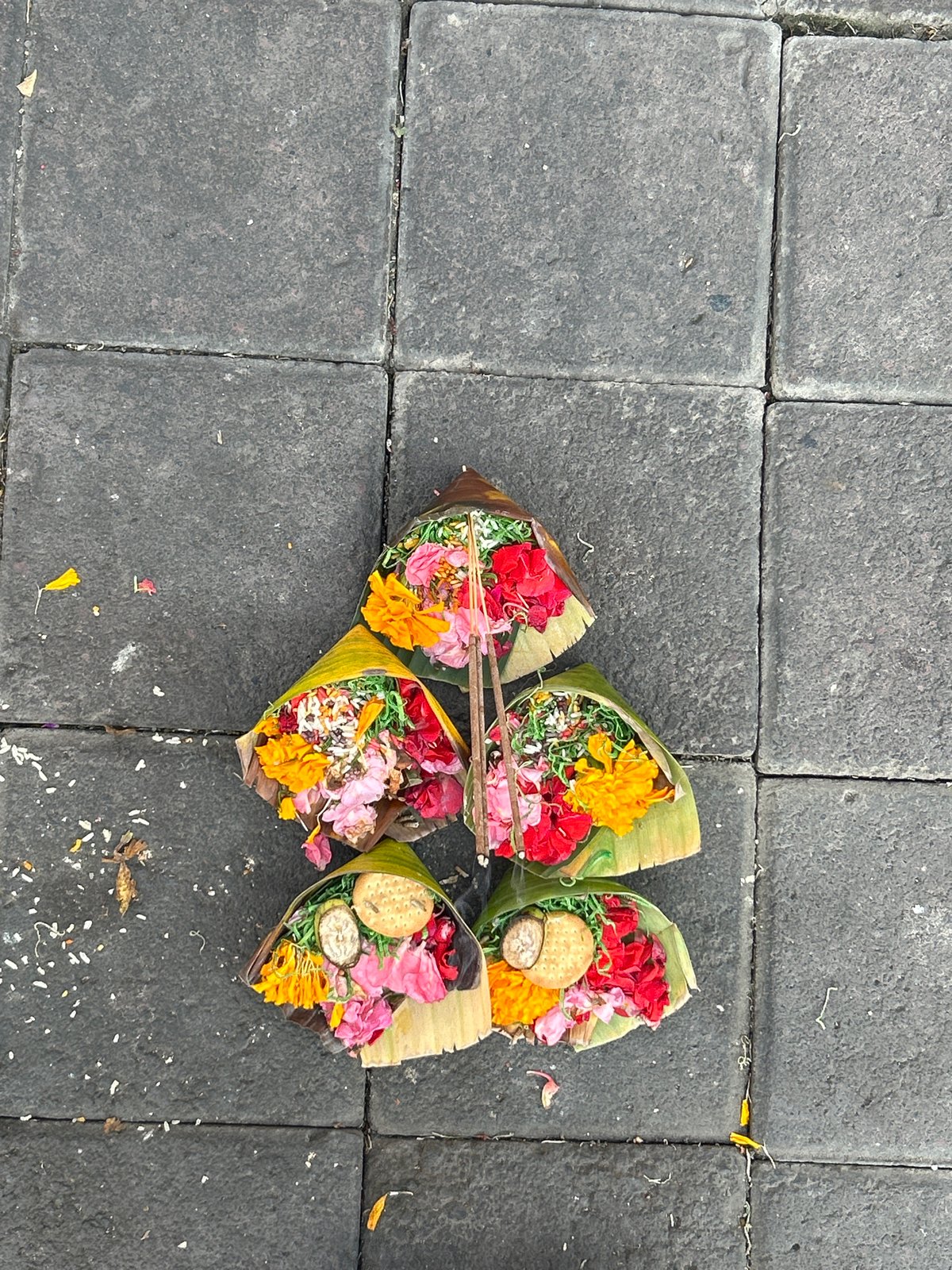North Kuta street life: scooters, offerings, and sidewalk activity