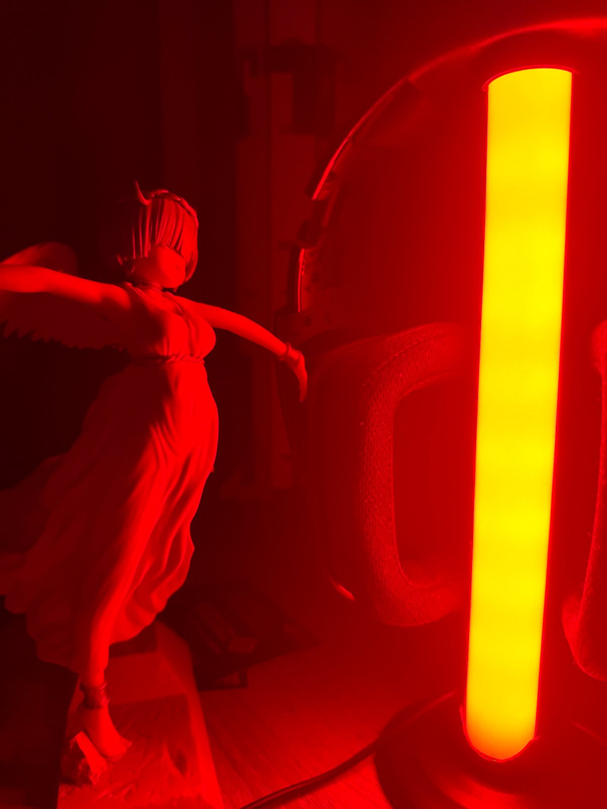 Collector documents anime figurine collection under colored LED lighting