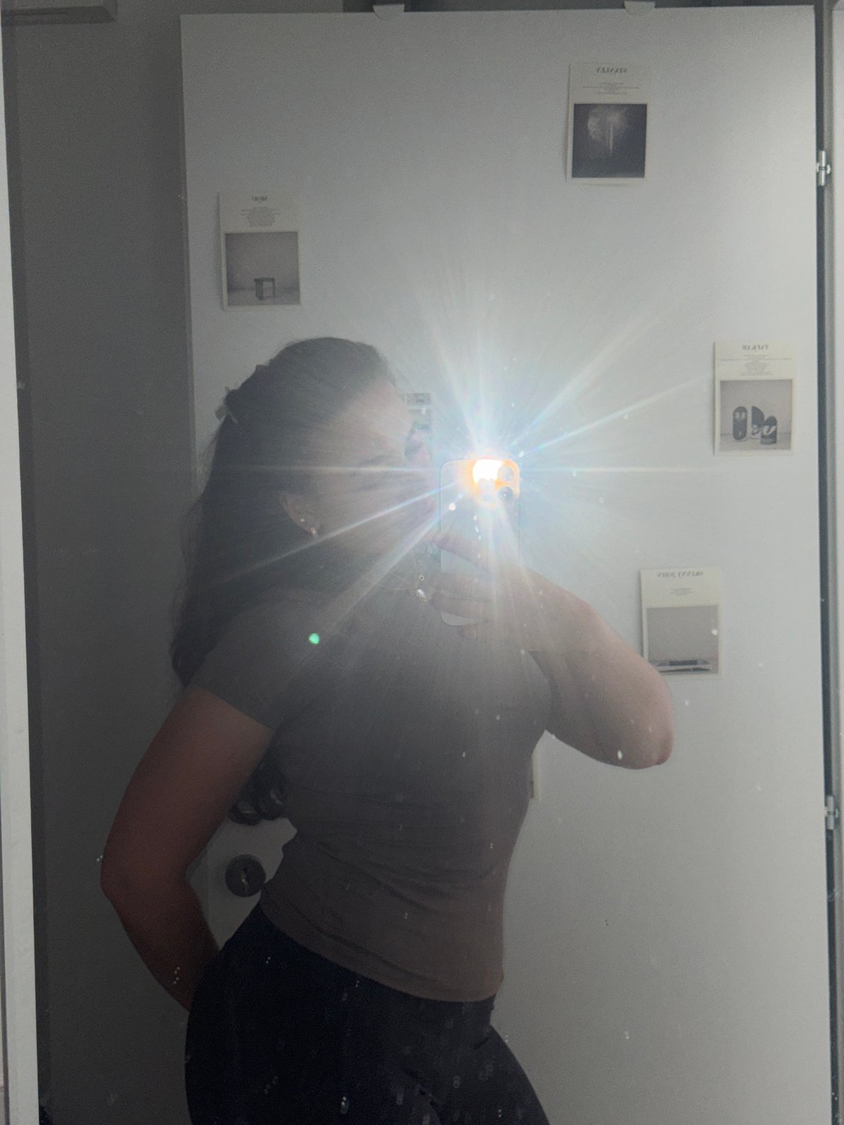 Mirror selfie with flash captured in Milan indoor setting