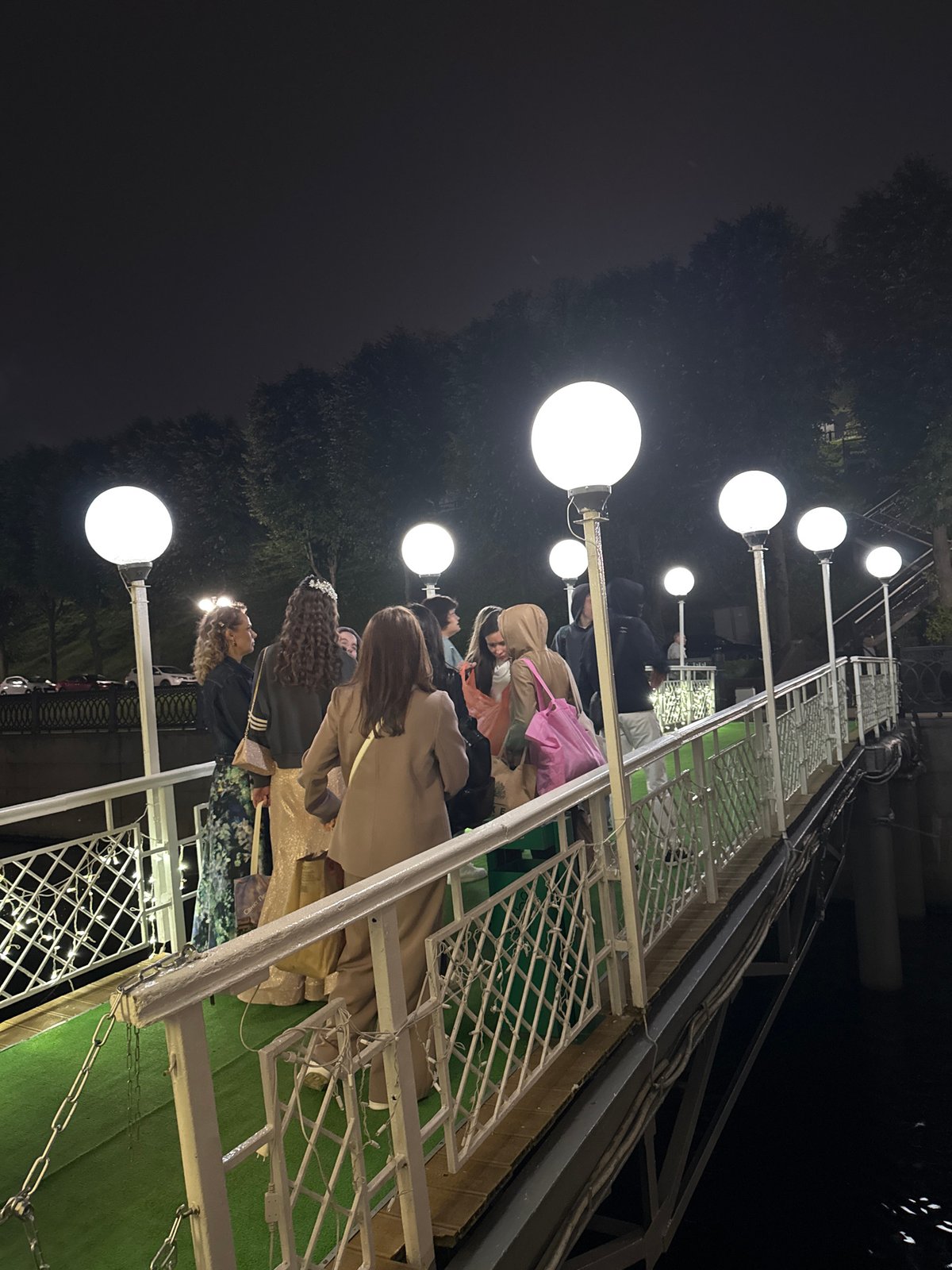 Evening gathering on a pier and boat, coastal Russia