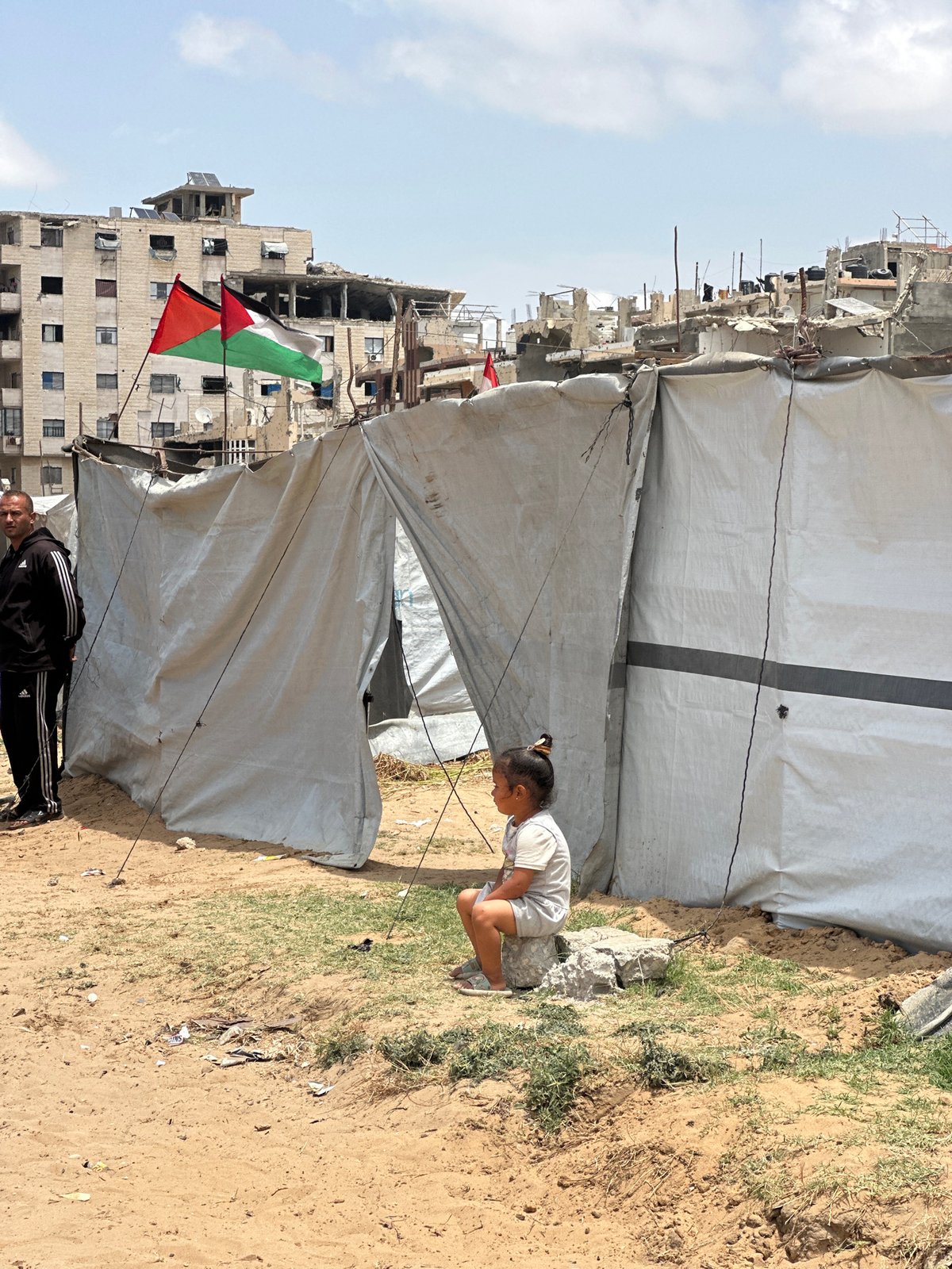 Children collect water at tent settlement in Gaza