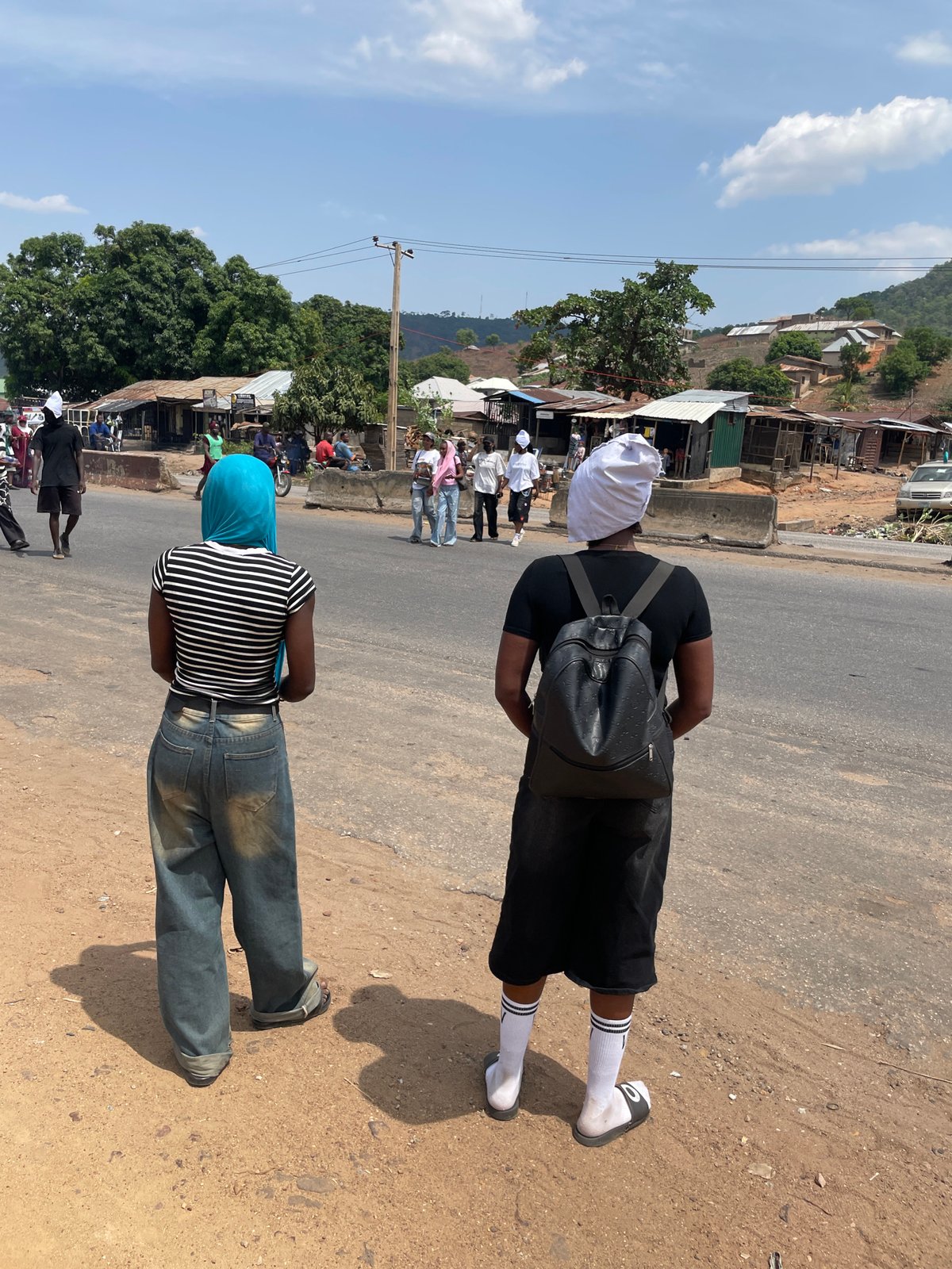 Crowd in white head coverings marches through Lokoja streets