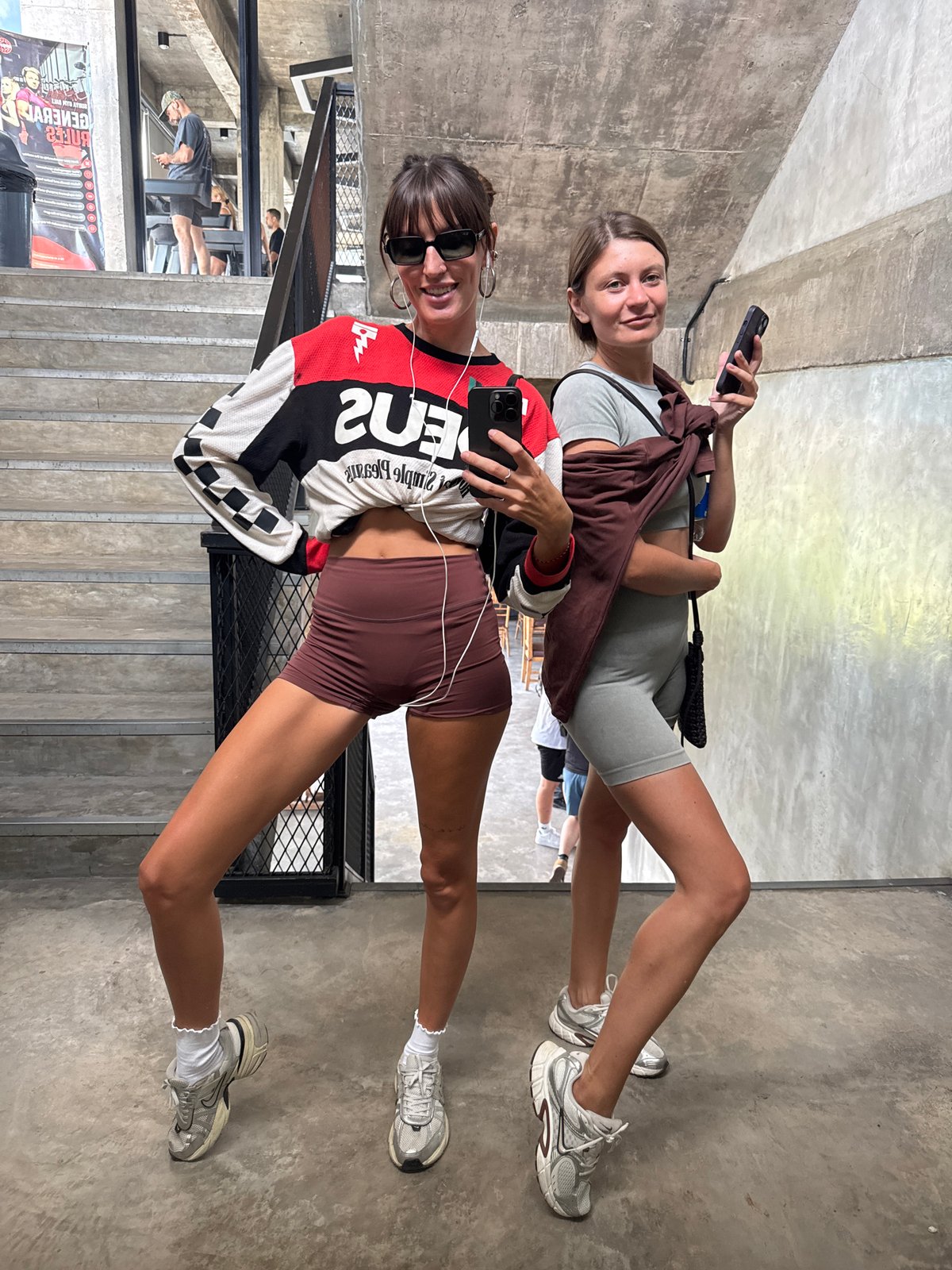 Women film mirror selfies at Mengwi gym early morning