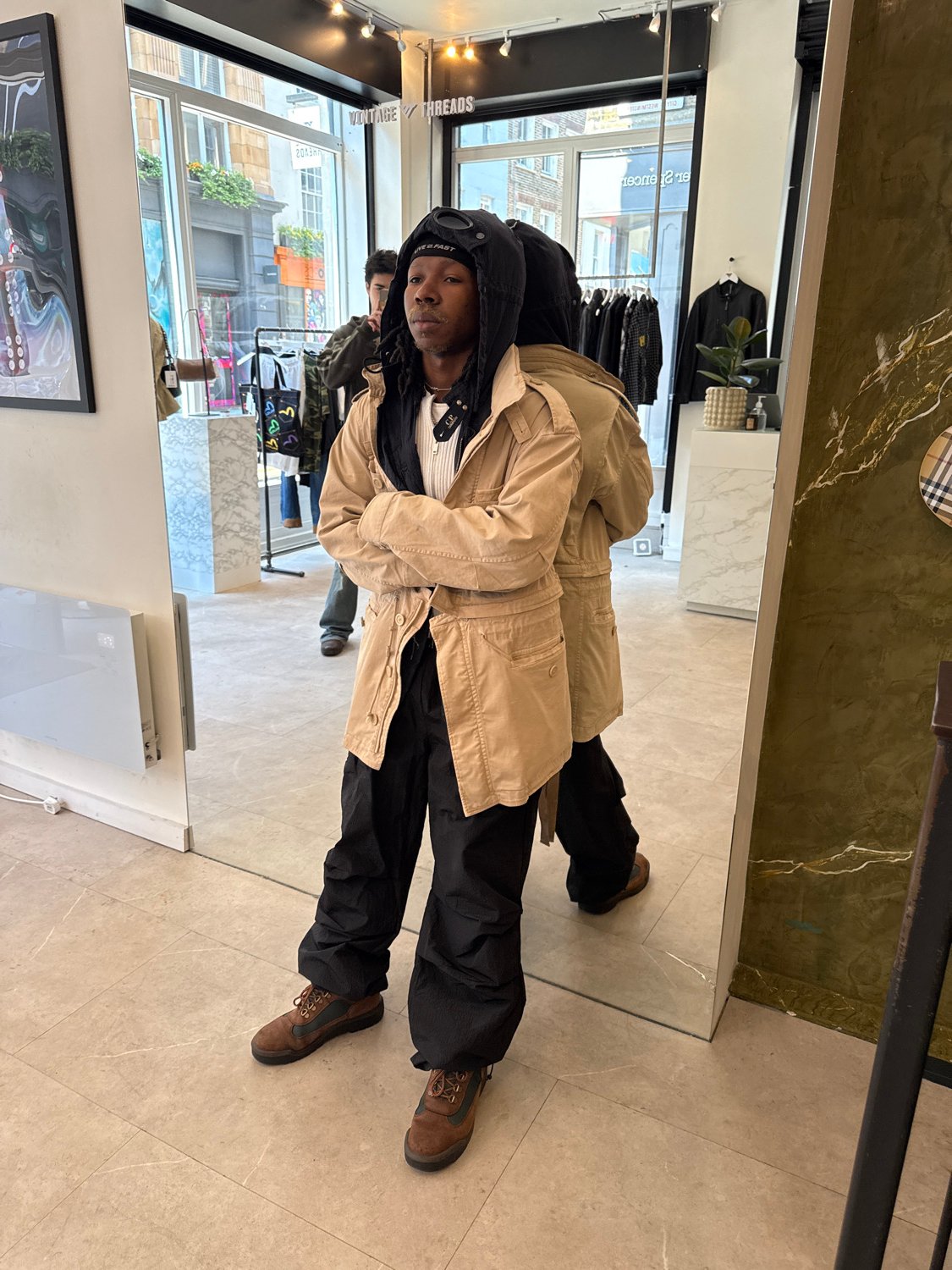 Customer tries on clothes at London vintage store
