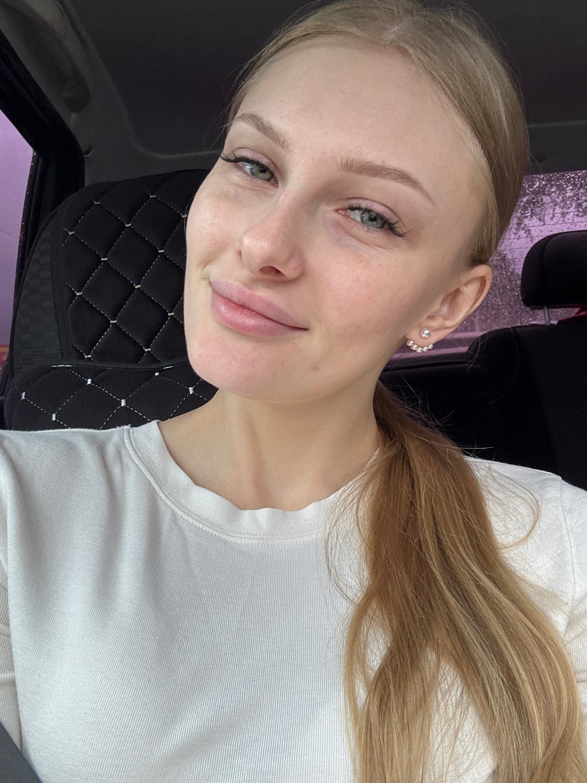 Woman photographed during car ride through rainy Perm streets