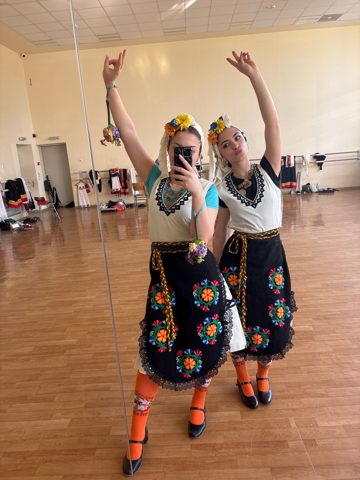 Traditional Bulgarian folk costume gathering captured in Sofia dance studio