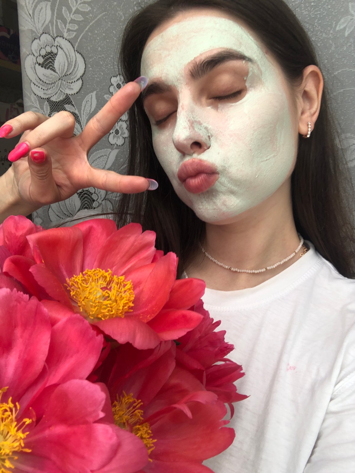 Woman documents morning skincare routine with peonies in Russia