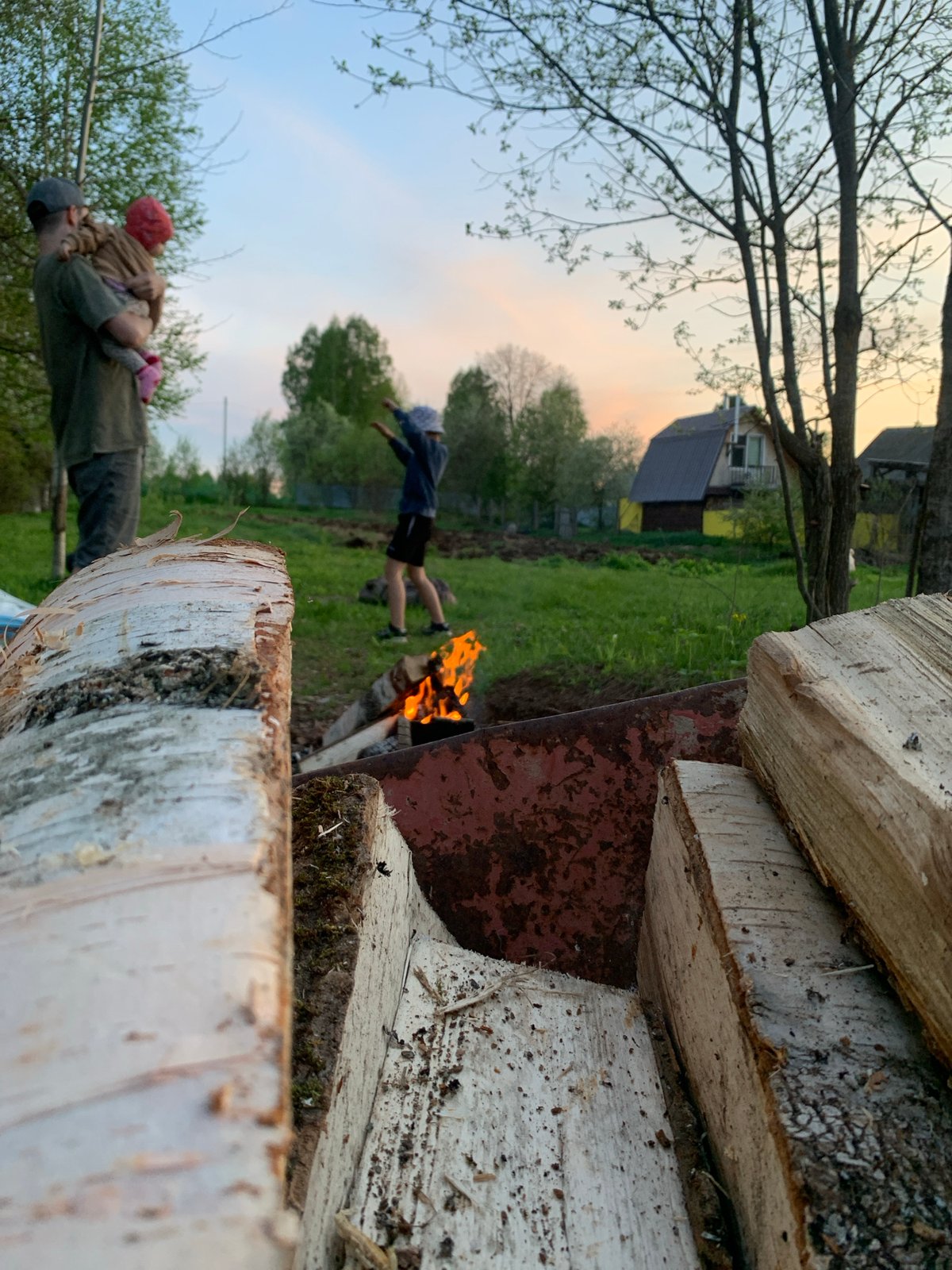 Family gathering with campfire and sunset documented in Zasechnyi