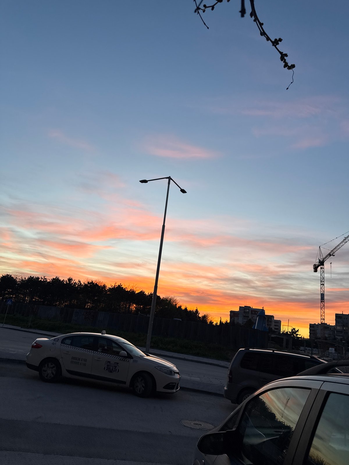Sunset observed over Plovdiv street scene with construction crane