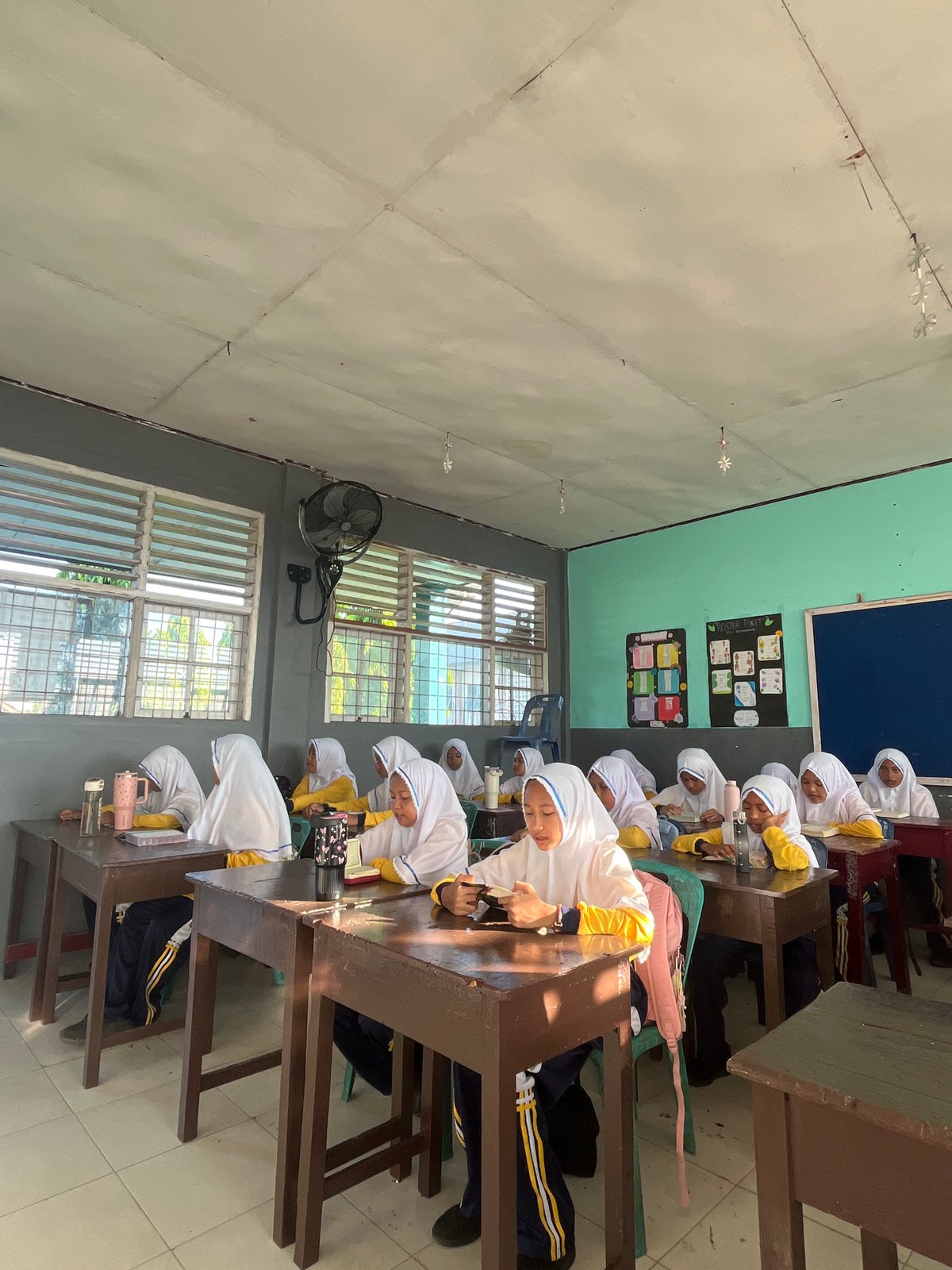 Students reading at their desks in a Lhokseumawe classroom