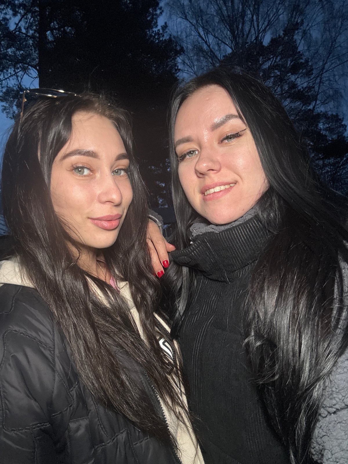 Women take evening selfies in Chaikovsky, Russia