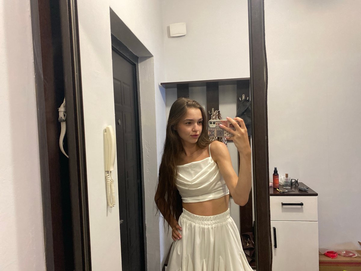 Indoor selfie session mixing outfit looks and skincare