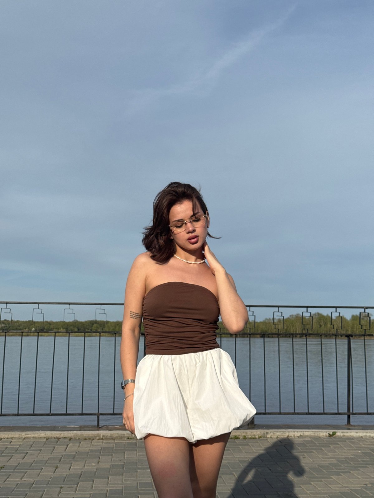 Woman poses for photos along Kama River waterfront in Sarapul