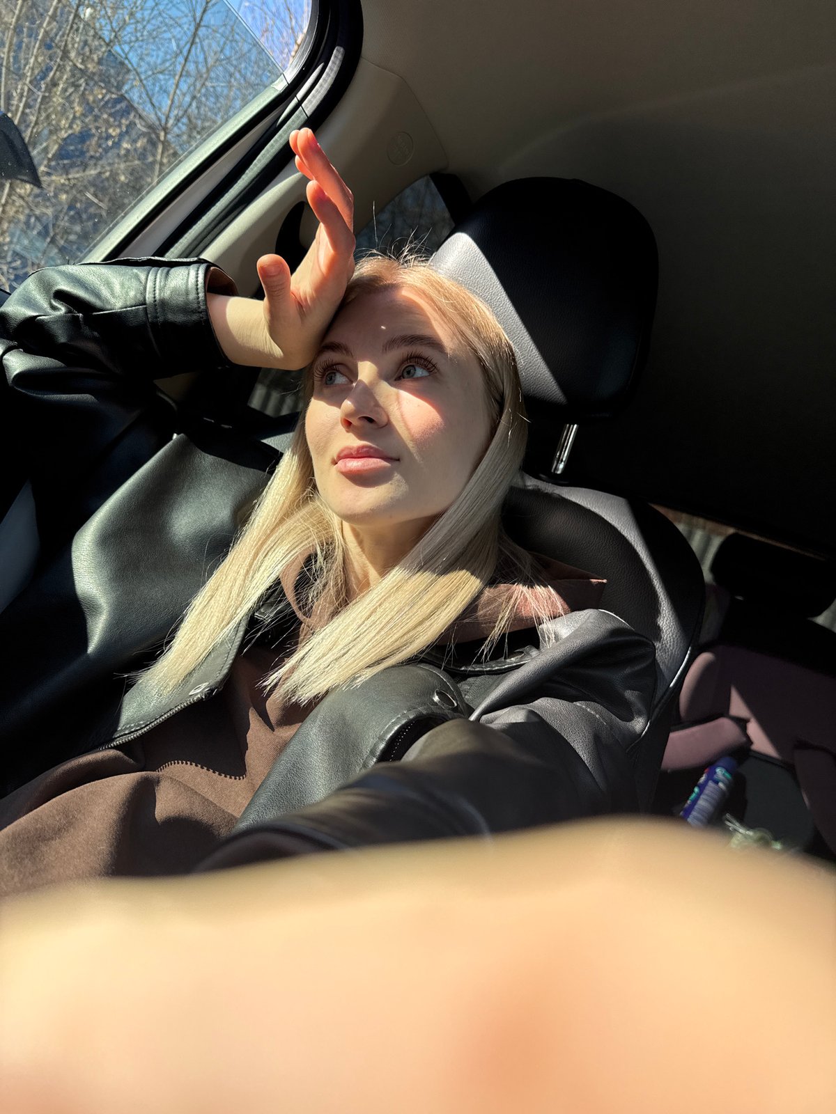 Woman photographs selfies near cinema and gas station in Izhevsk