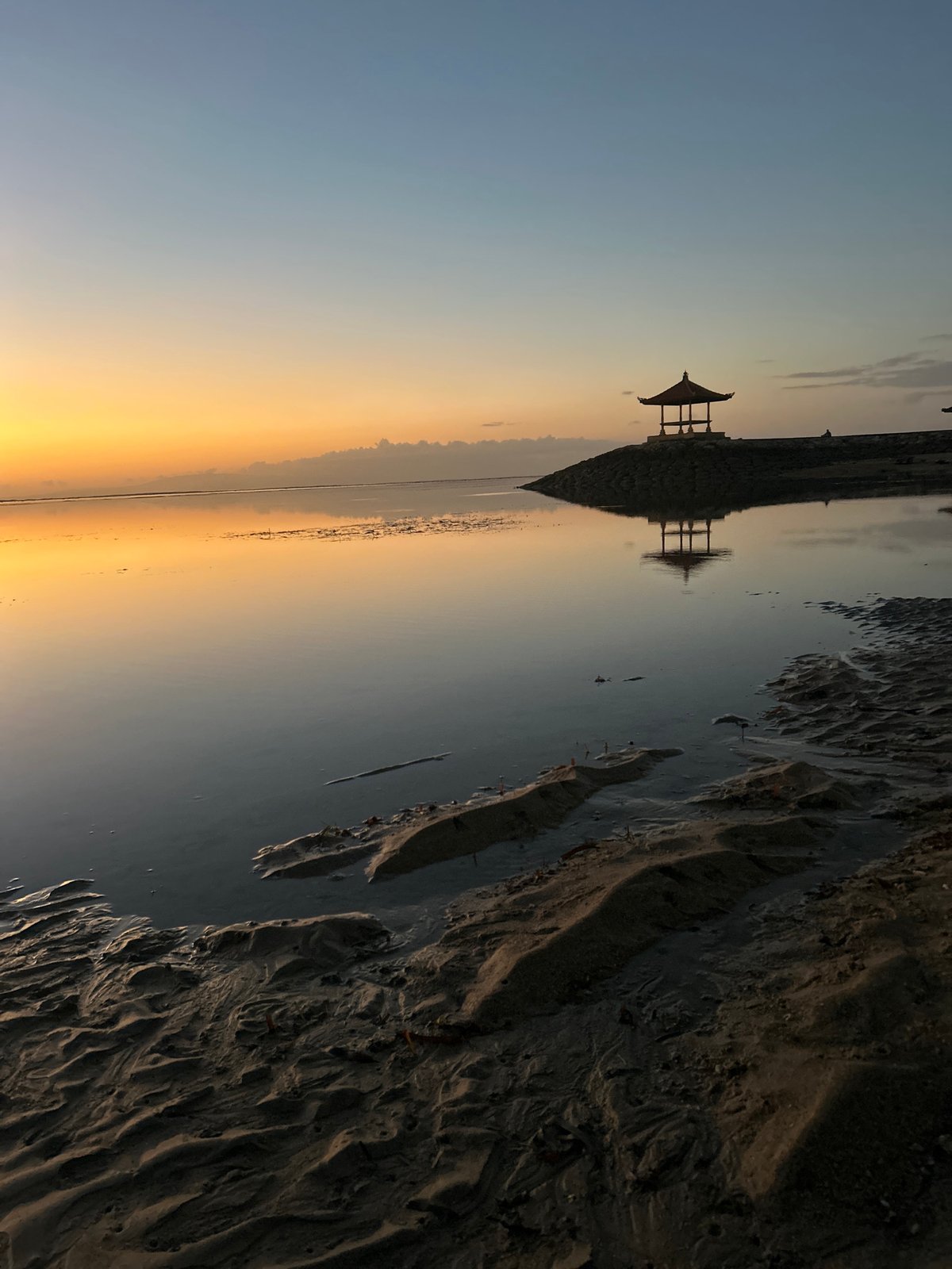 Dawn light over Sanur Beach, Bali — sky, water, gazebos