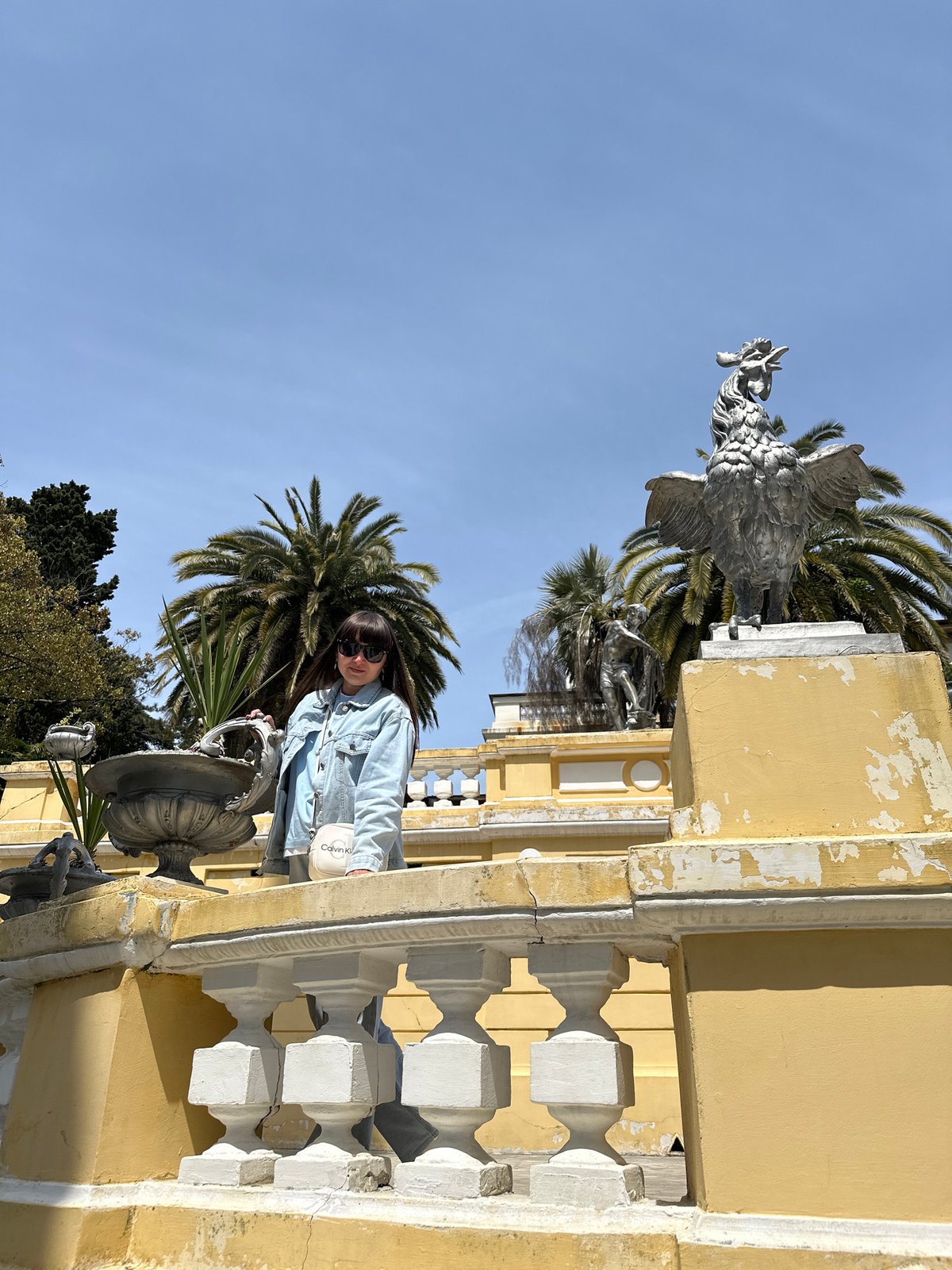 Woman enjoys morning photo session in blooming Sochi gardens
