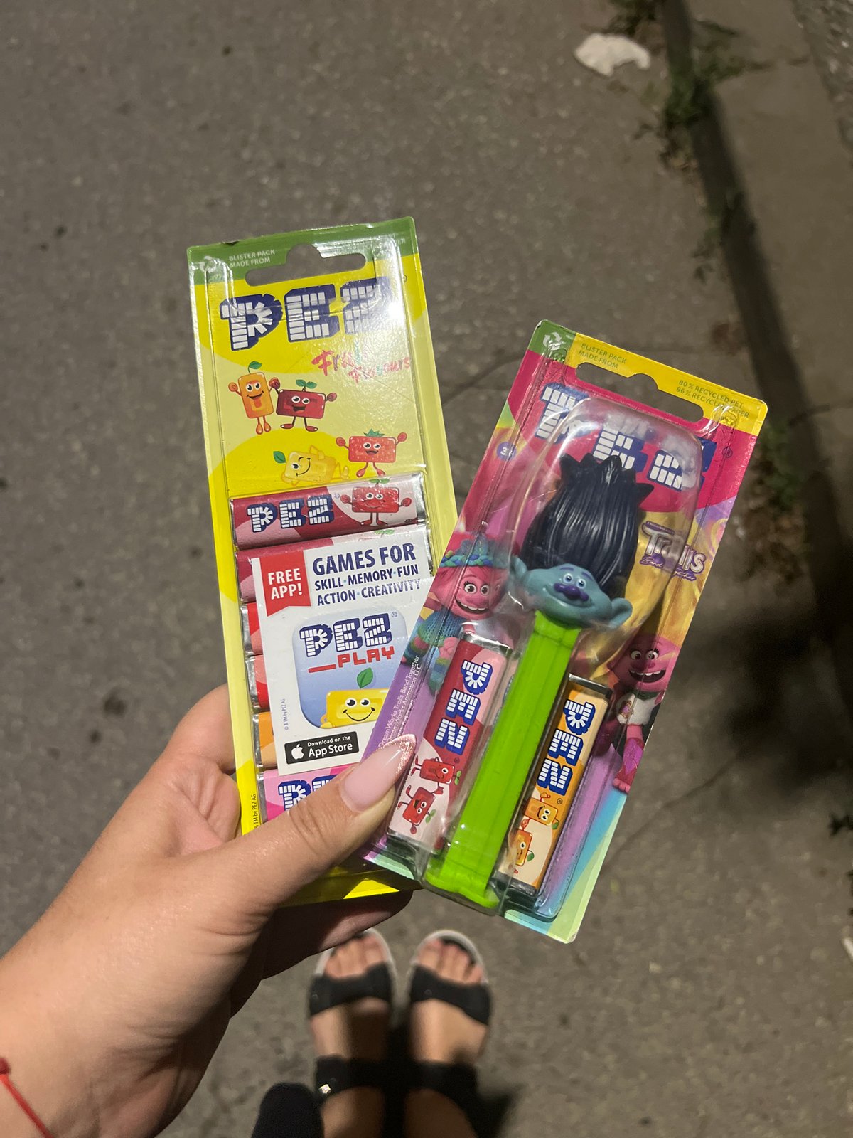 Person displays packaged PEZ dispensers on Sofia street