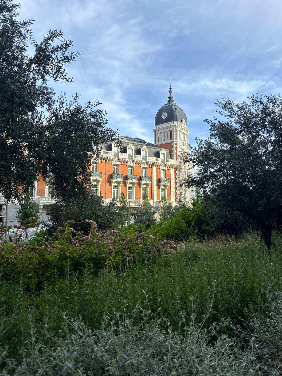 Tourist captures Madrid landmarks during afternoon walking tour