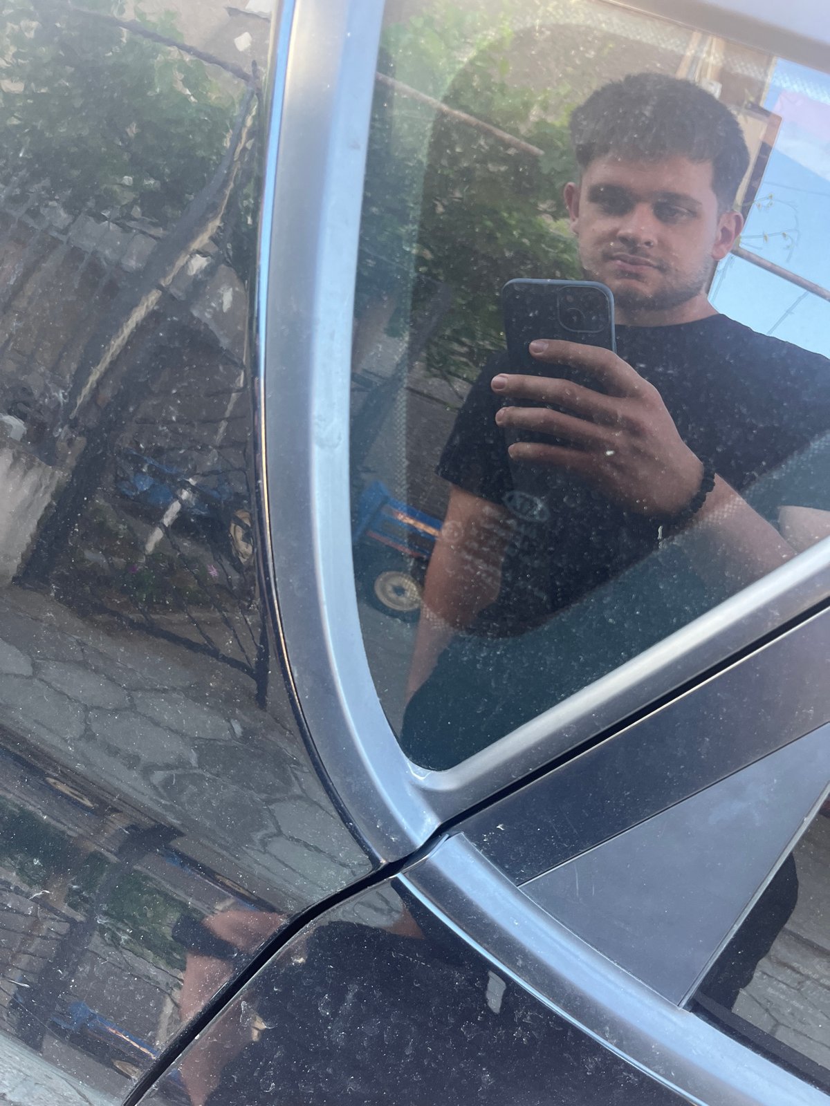 Car maintenance and romantic balloon display captured in Bulgarian village
