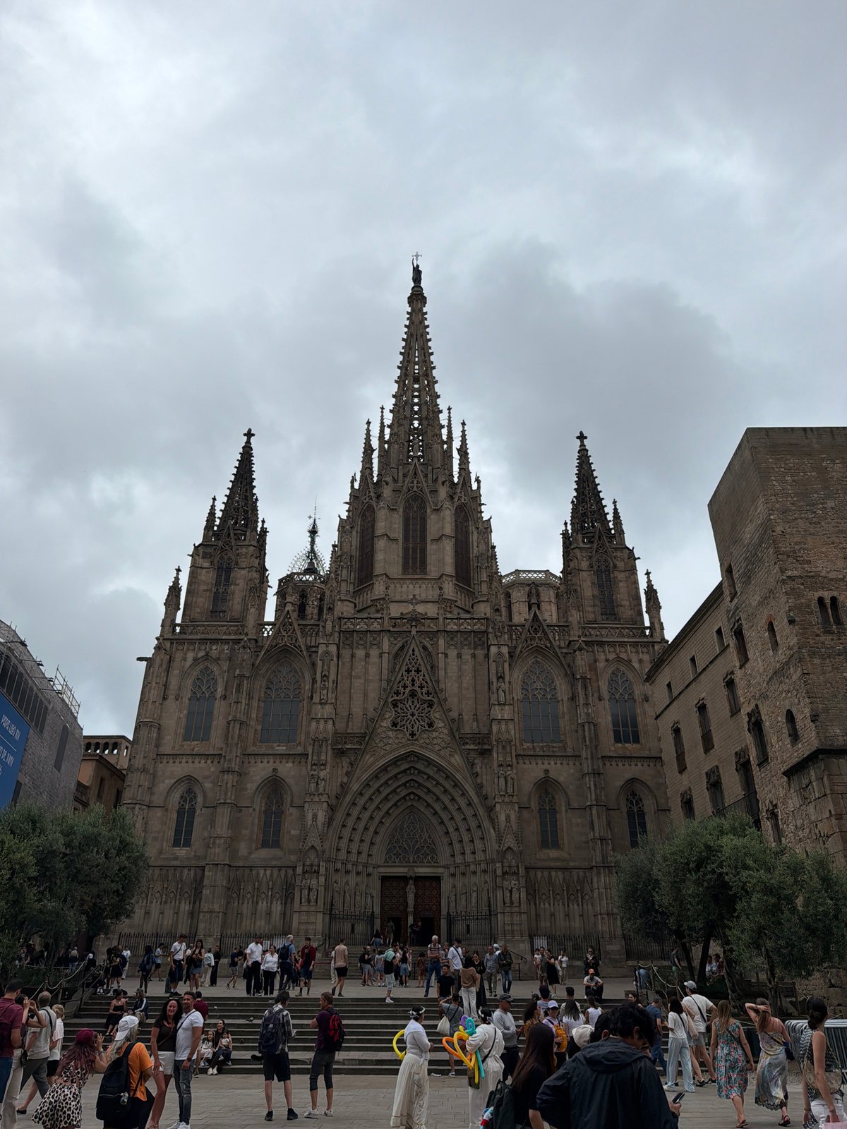 Tourist explores Barcelona Cathedral and Gothic Quarter on overcast afternoon
