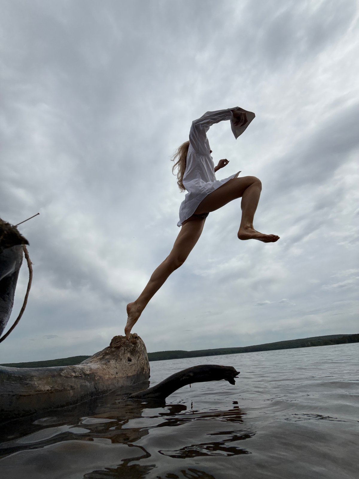 Woman photographed leaping from tree trunk in Chaikovsky, Russia