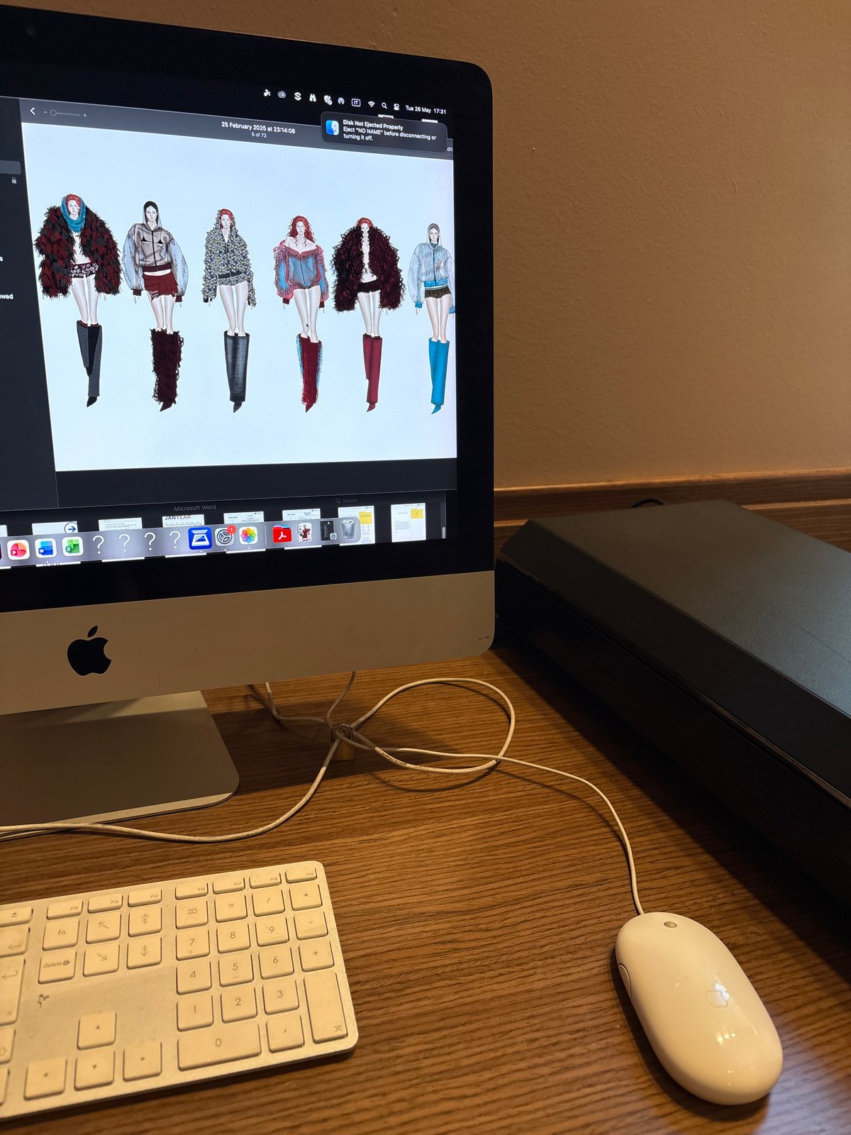 Fashion designer works on iMac in Milan workspace