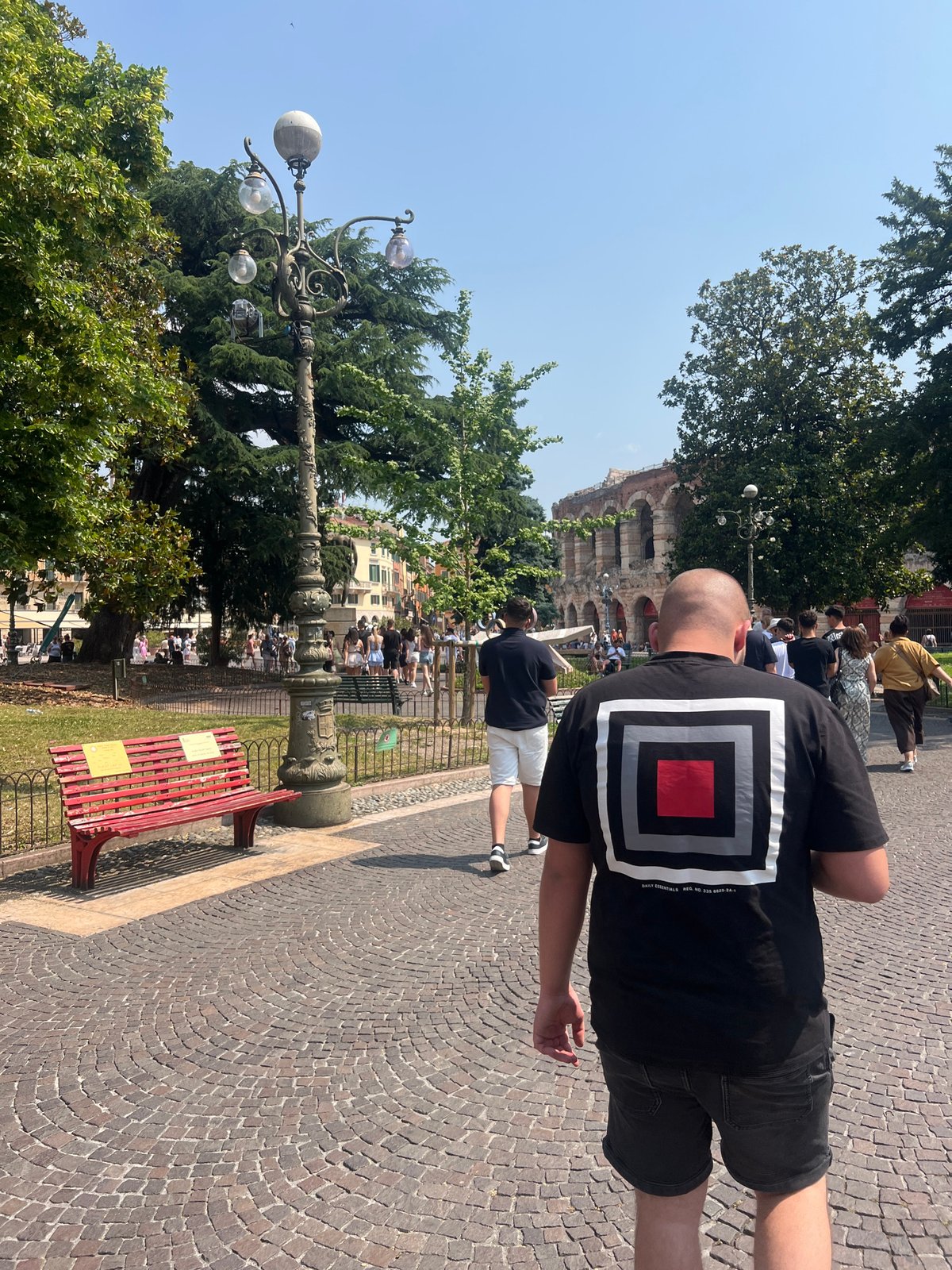 Morning tourist activity captured around Arena di Verona cobblestone streets