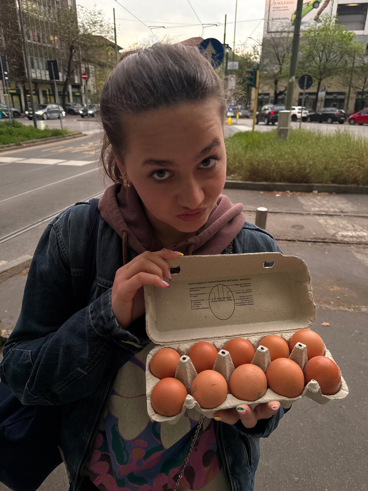 Woman holds egg carton in Milan street scene