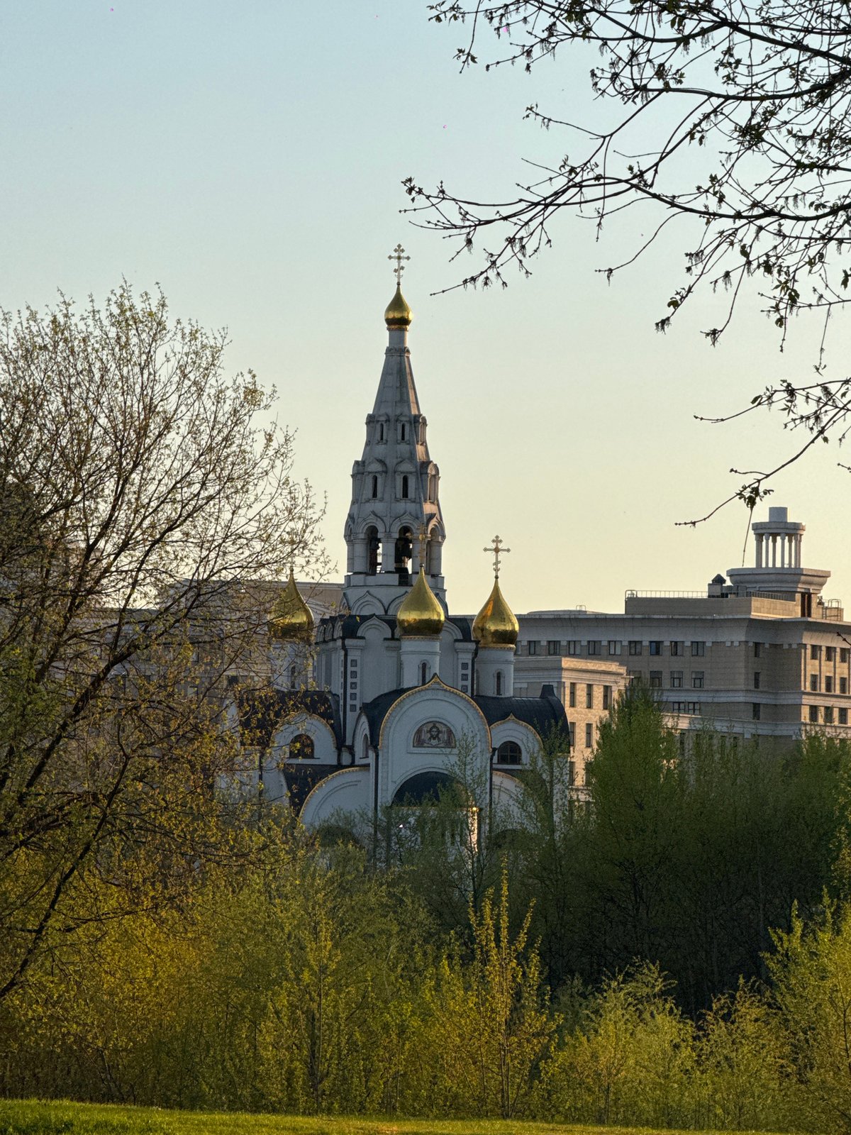 Moscow spring afternoon captured through urban architecture and blossoming trees