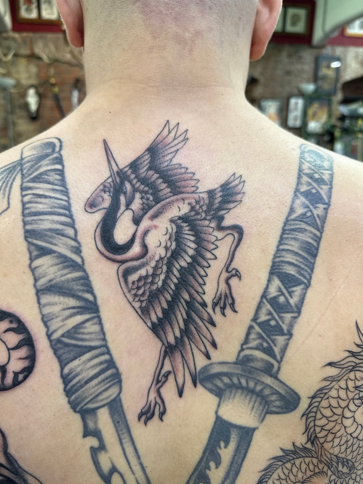 Tattoo session featuring Japanese sword designs documented in Moscow