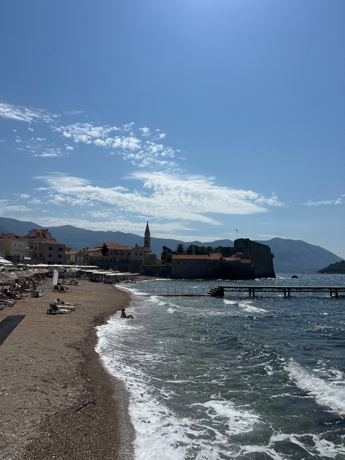 Summer morning unfolds in Budva: tourists, musicians, beach life