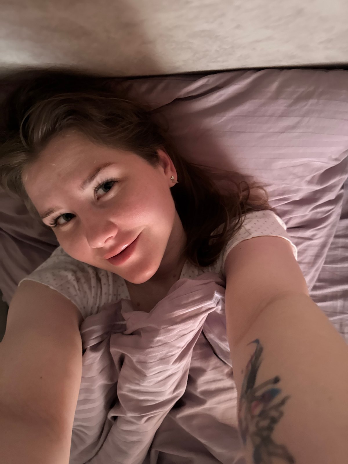 Woman rests on bed in Gornyi, Russia