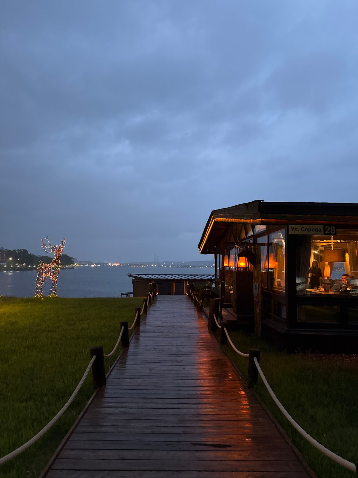 Evening waterfront scenes documented at Votkinsk restaurant terrace area