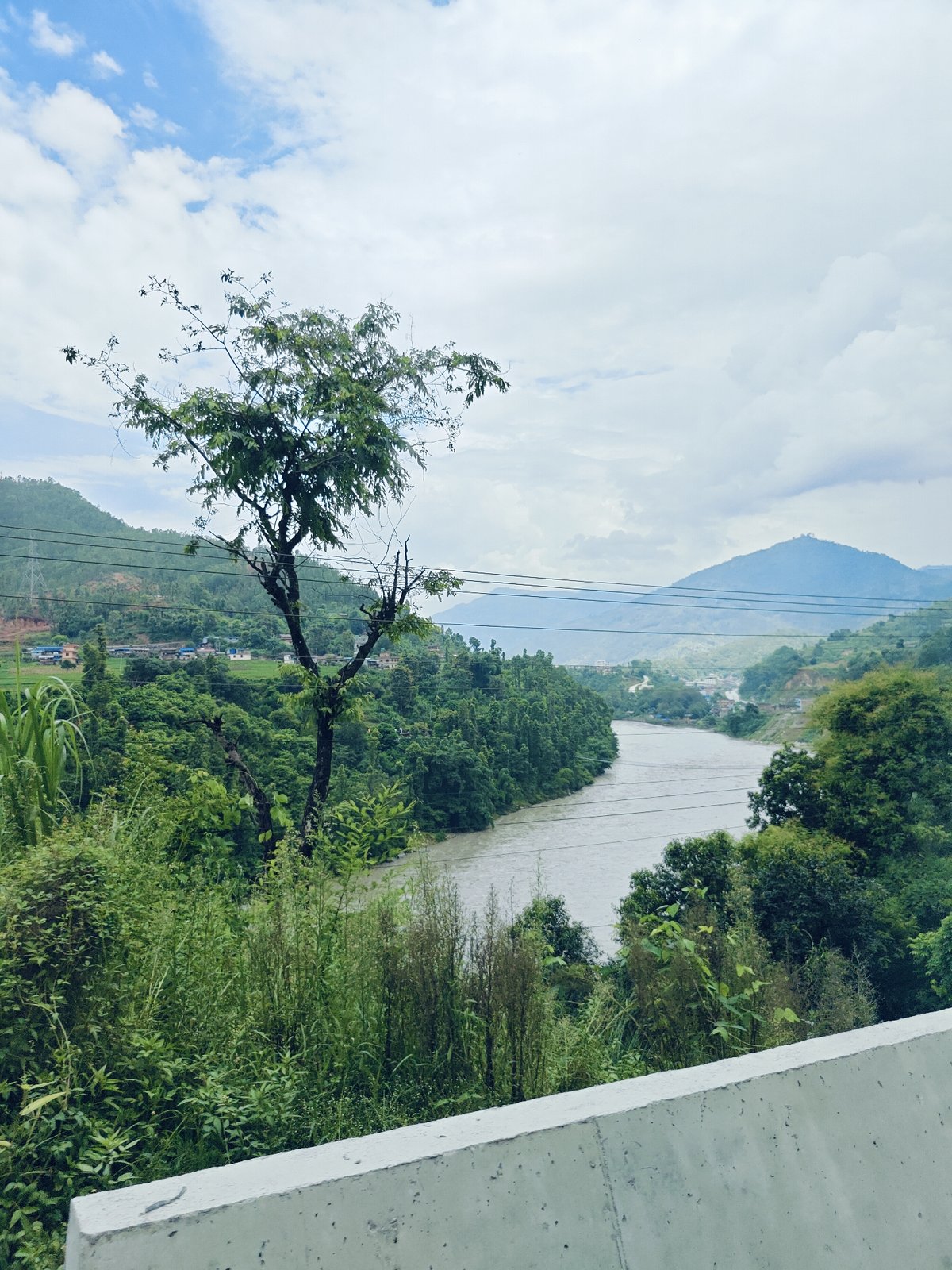 Roadside views of river valley and green hills in Galchhi, Nepal