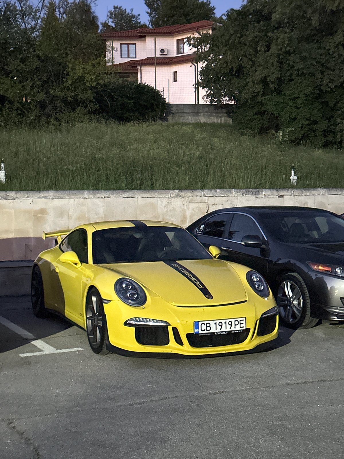Two Porsches parked at dusk in Arbanassi, Bulgaria