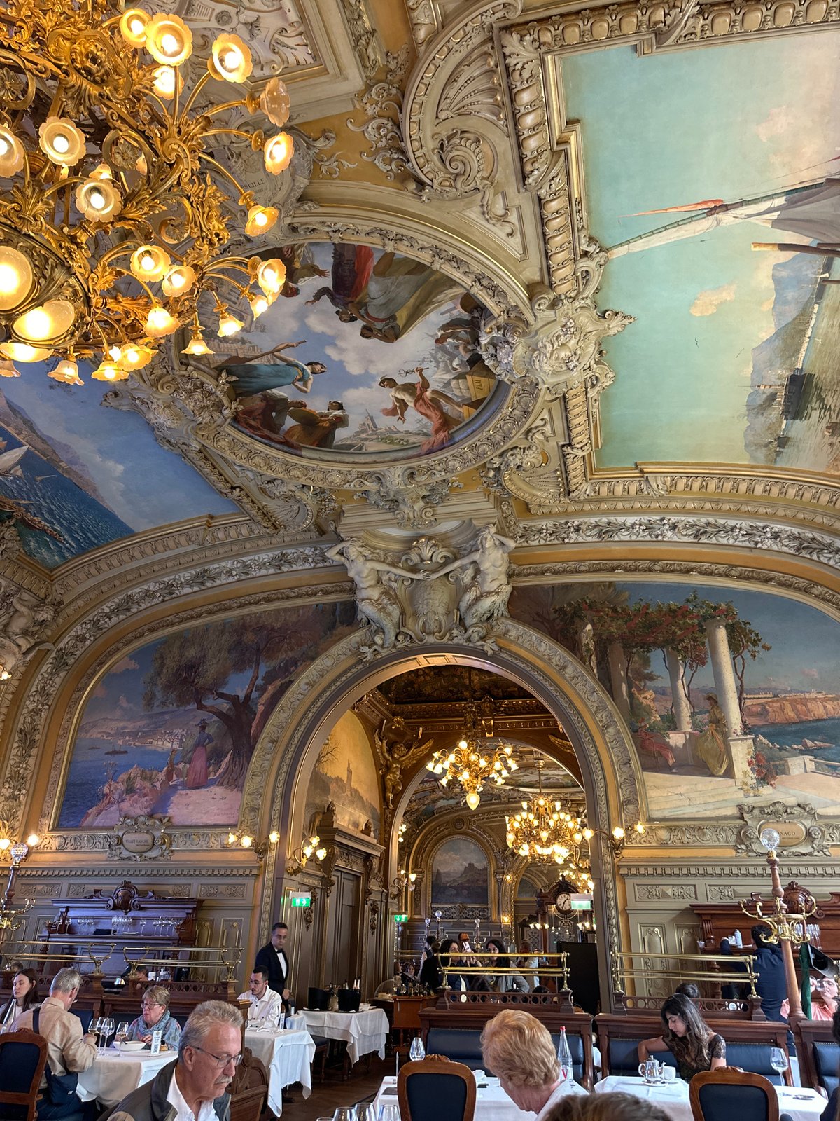 Luxury dining experience documented at ornate Parisian restaurant