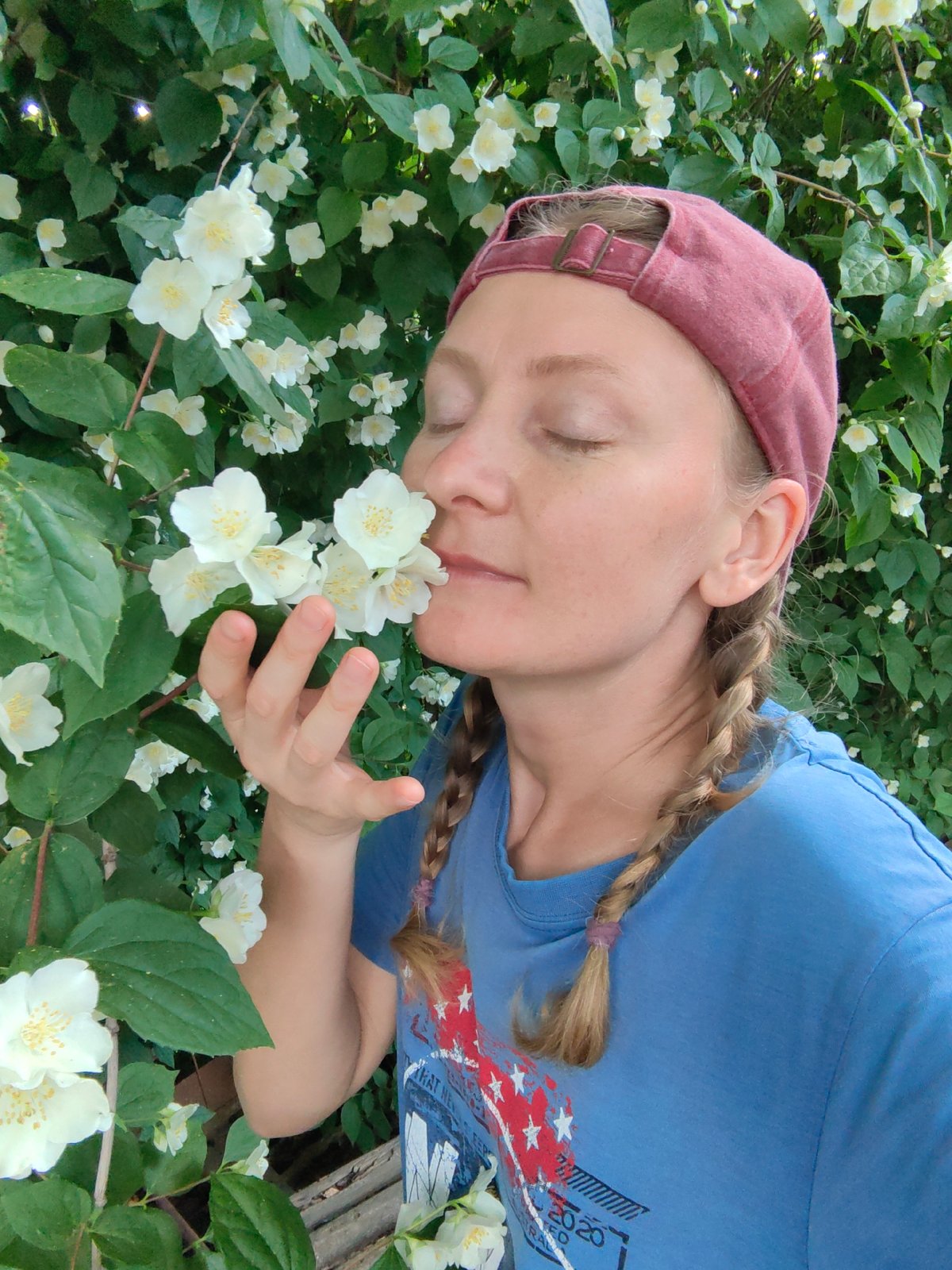 Woman tends blooming garden in Ukrainian village