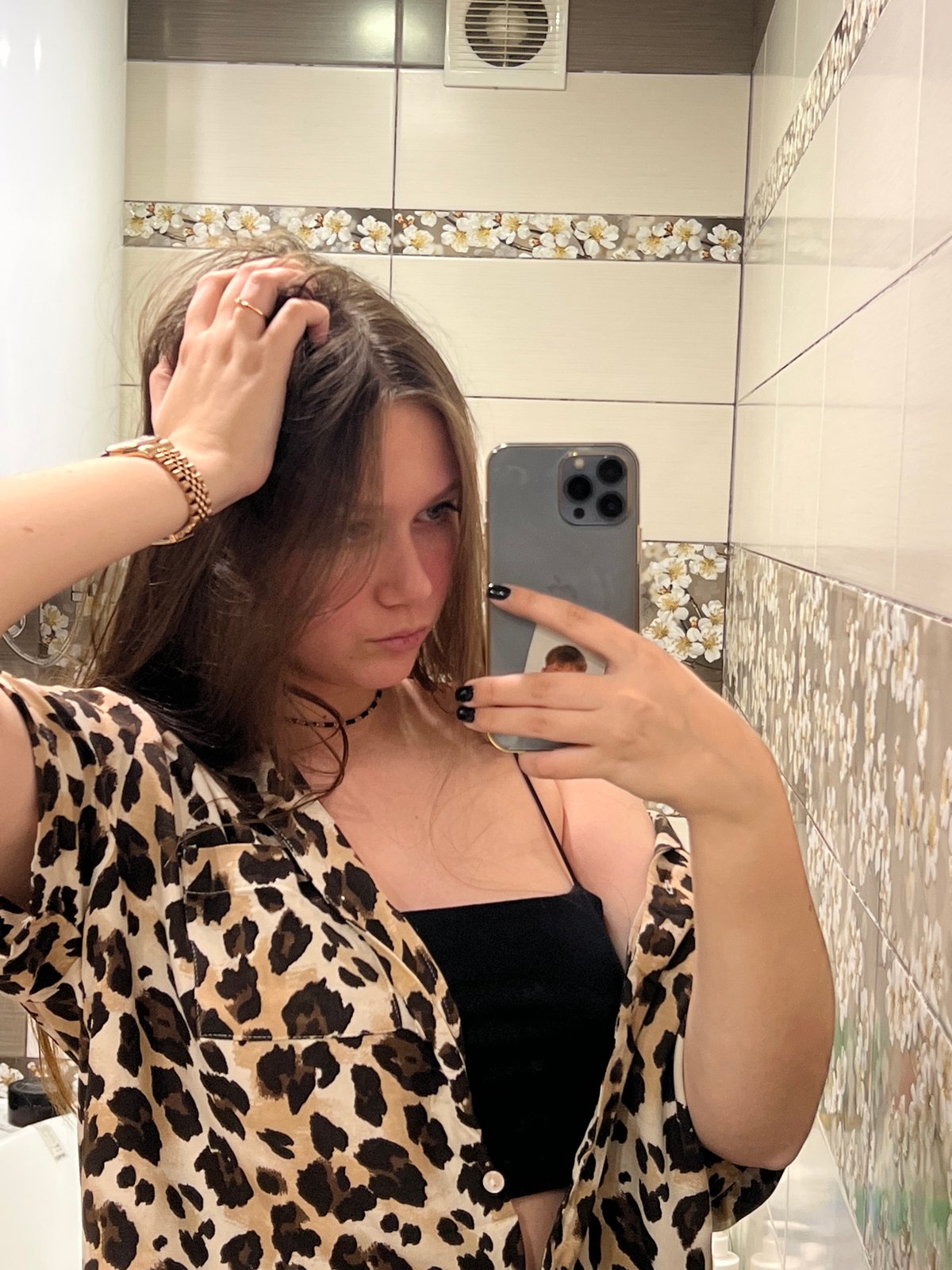 Woman takes multiple selfies in leopard print in Chaikovsky