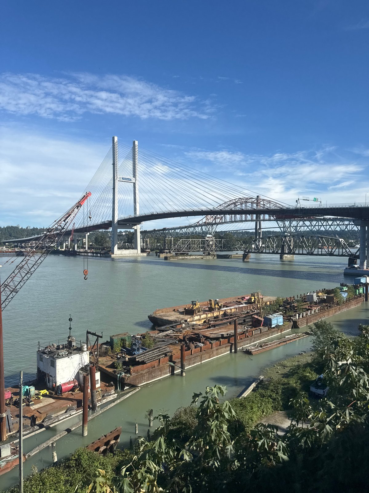 Moored barges on the Fraser River under clear skies