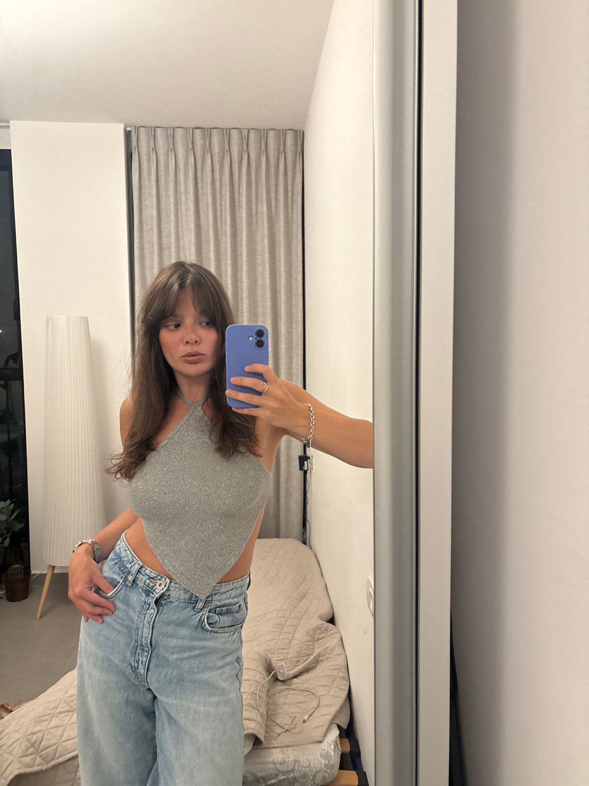 Mirror selfie in a Tel Aviv elevator, gray halter and wide-leg jeans