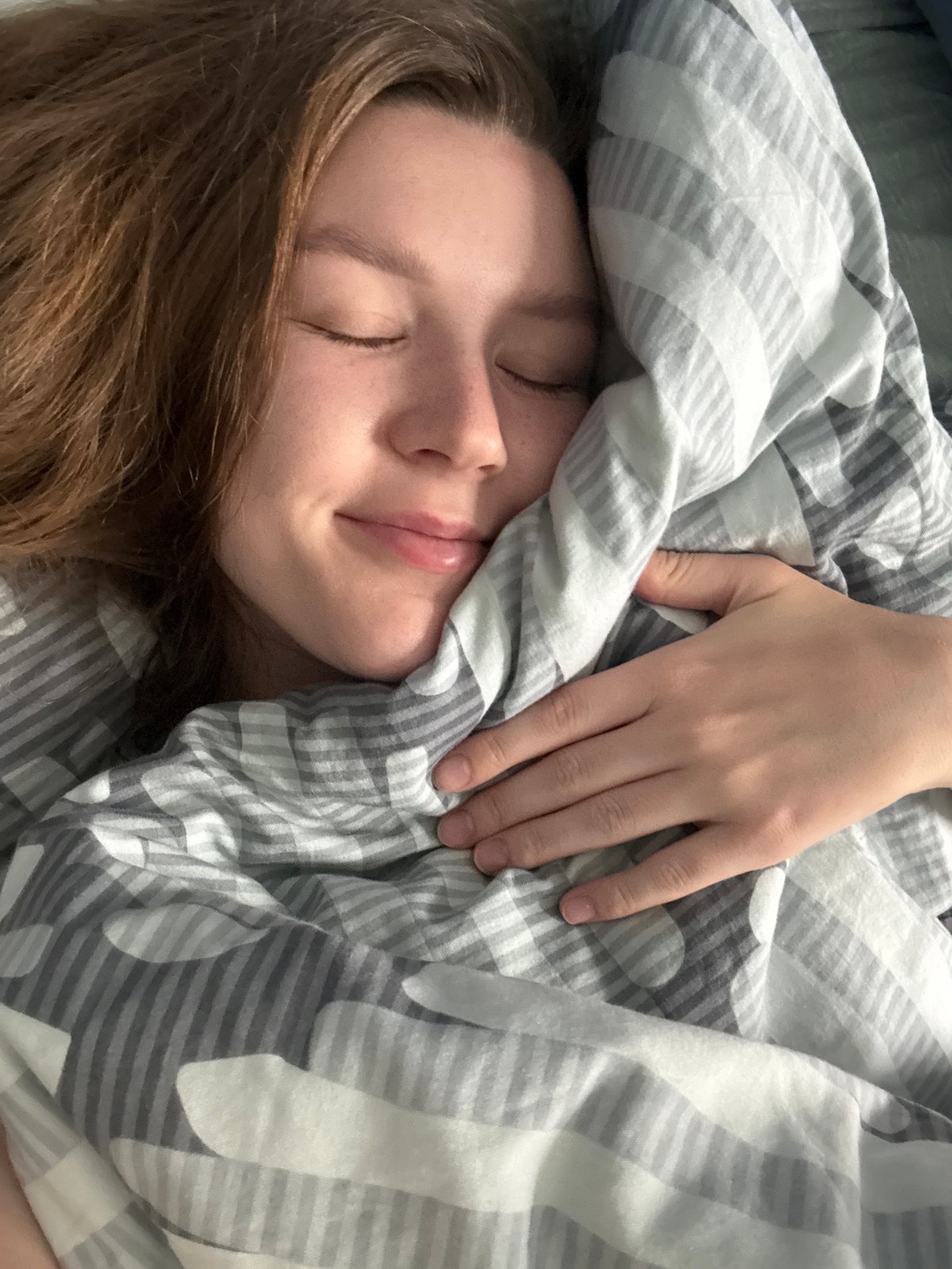 Morning moments with sleeping woman and playful kittens in Izhevsk