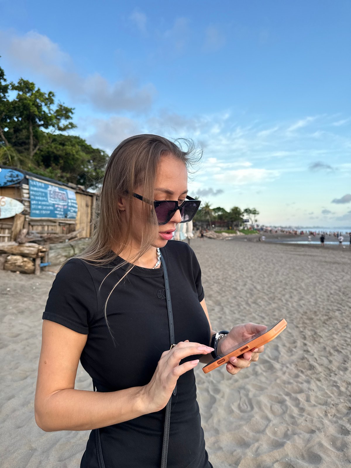 Woman with smartphone spotted on North Kuta beach