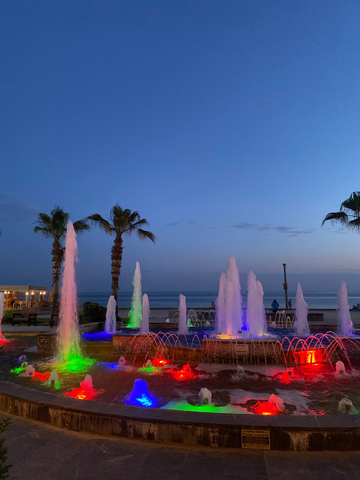Evening fountain display illuminates Alanya coastal promenade