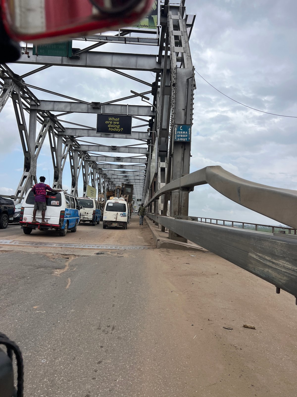 On the Onitsha Bridge, mid-morning traffic and heavy machinery