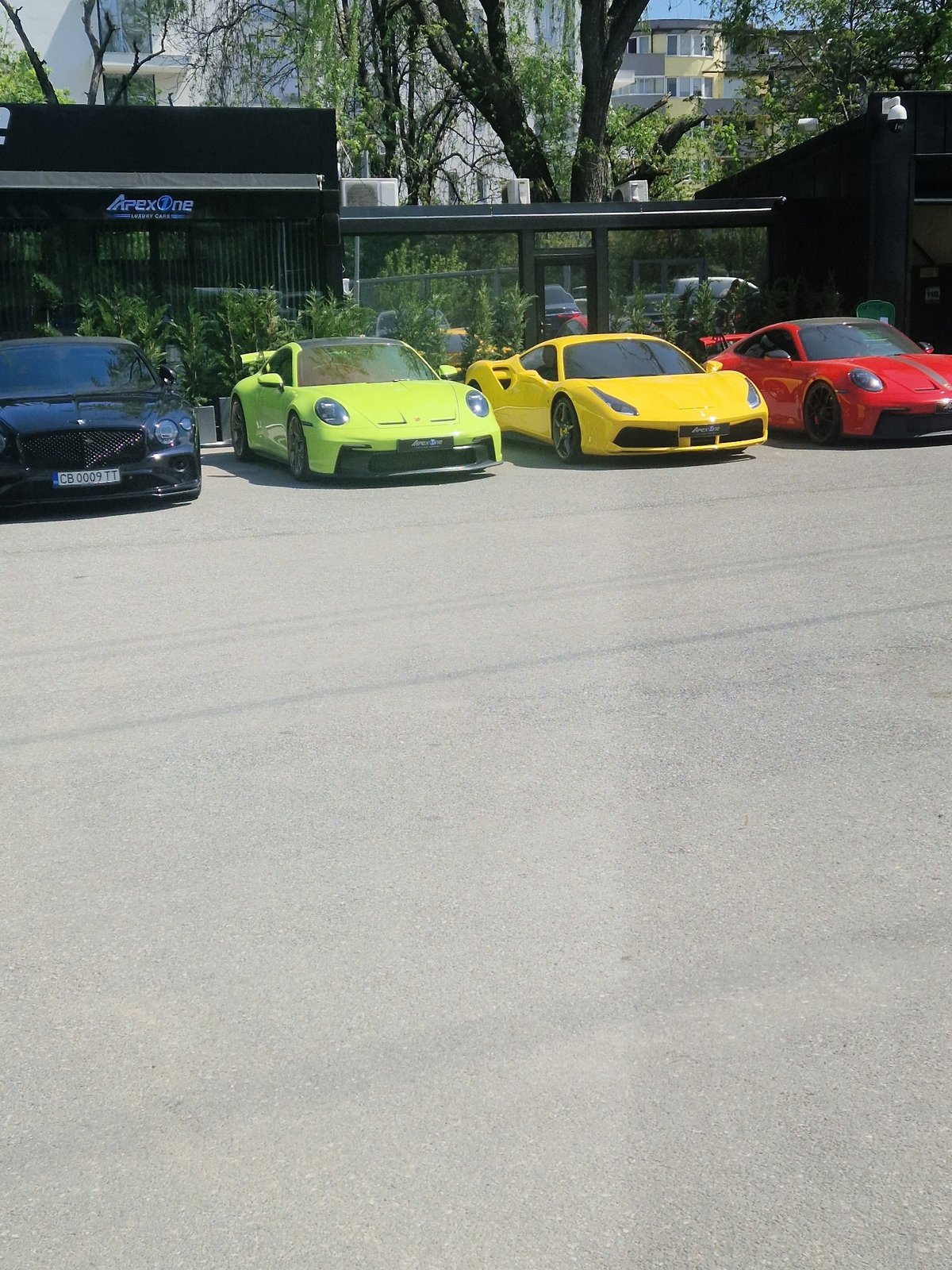 Luxury cars including Aston Martin spotted in sunny parking area