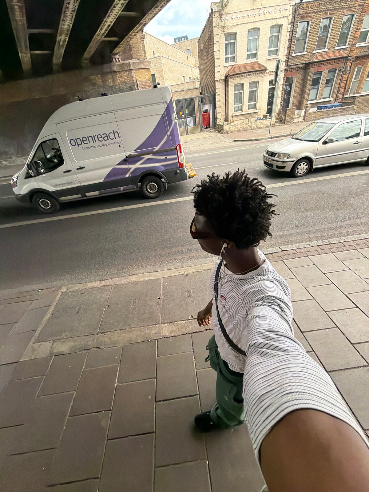 Person takes selfie on London sidewalk