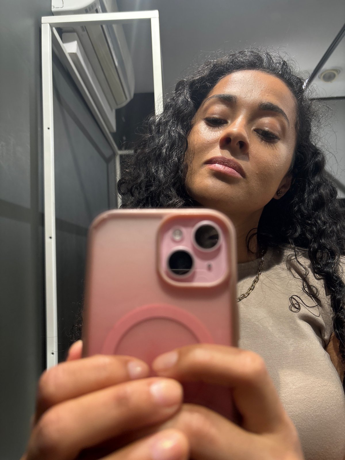 Woman takes selfies in Luxembourg clothing store fitting room