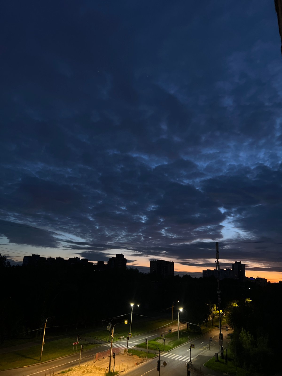 Dusk settles over Shushary's skyline, clouds and orange light
