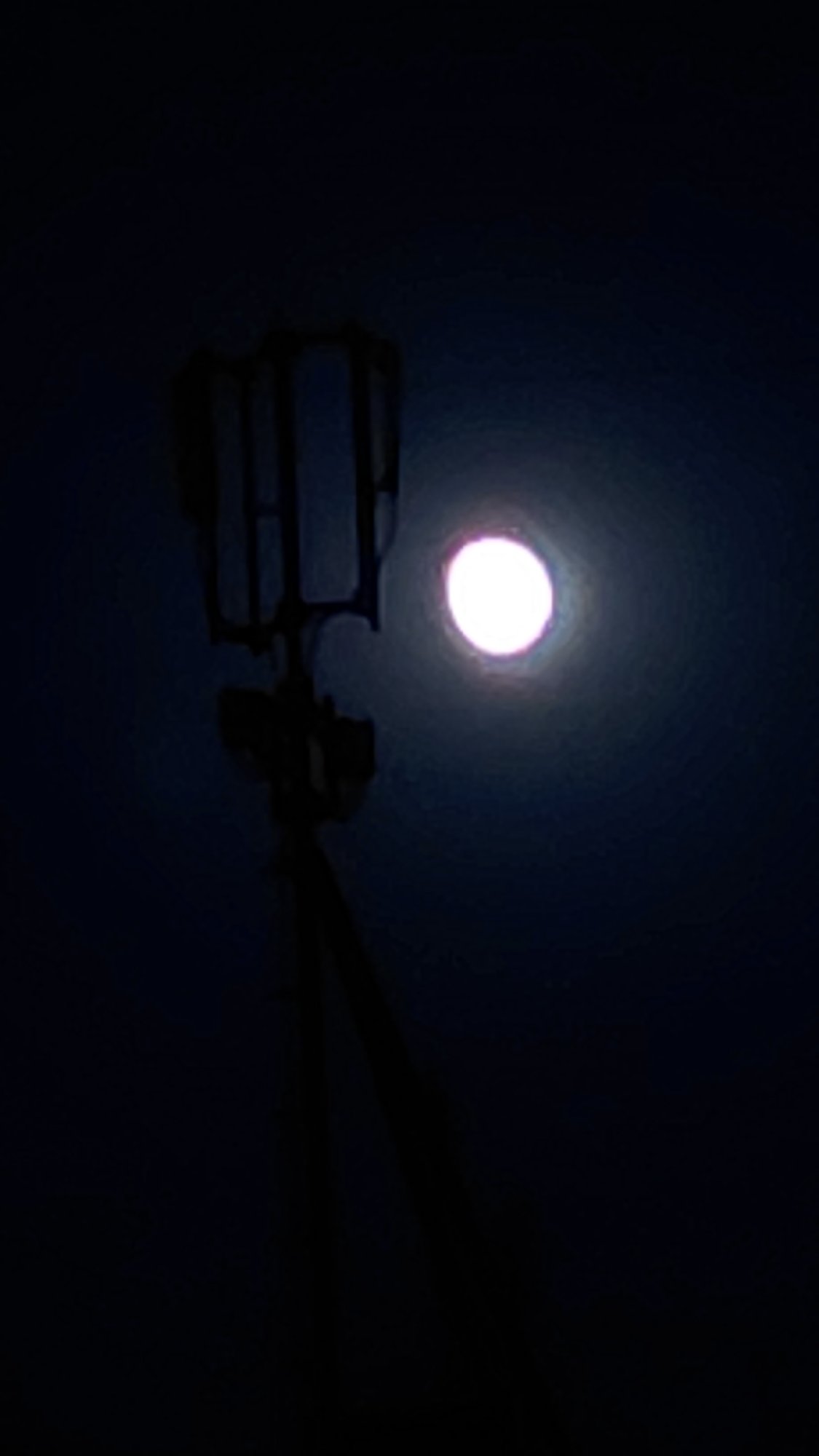 Full moon rises behind a cell tower in Abovyan, Armenia