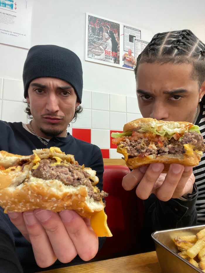 Two men dine at Five Guys restaurant in Paris